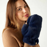 closeup of woman wearing mersea cozy cabin faux fur mittens in oxford blue