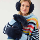 closeup of woman wearing mersea cozy cabin faux fur mittens scarf and earmuffs in oxford blue