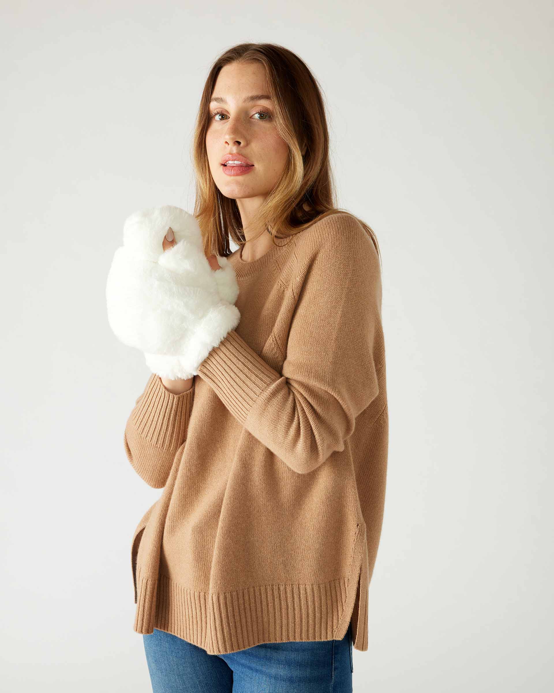 woman wearing mersea cozy cabin faux fur mittens in whisper white