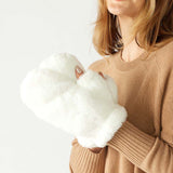 closeup of woman wearing mersea cozy cabin faux fur mittens in whisper white