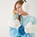 woman wearing mersea cozy cabin faux fur mittens and earmuffs in whisper white