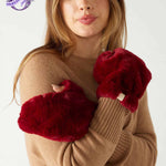 closeup of woman wearing mersea cozy cabin faux fur mittens in wine color