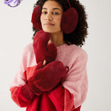 closeup of woman wearing mersea cozy cabin faux fur mittens and earmuffs in wine color