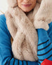 closeup of mersea cozy cabin faux fur scarf and mittens in oatmeal cream color
