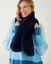 closeup of woman wearing mersea cozy cabin faux fur scarf in oxford blue