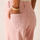 Person wearing pink pants with a neutral background