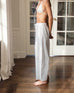 side view of woman wearing daisy eyelet pant in white