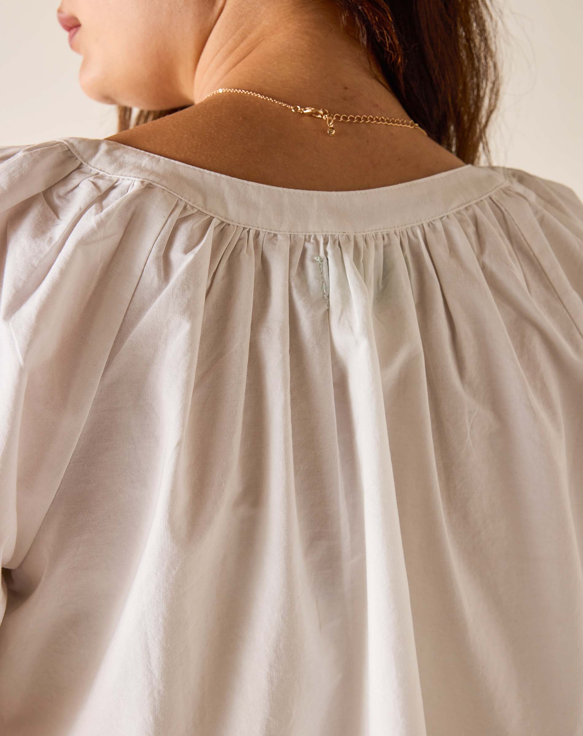 Close-up of a beige blouse with a blurred background