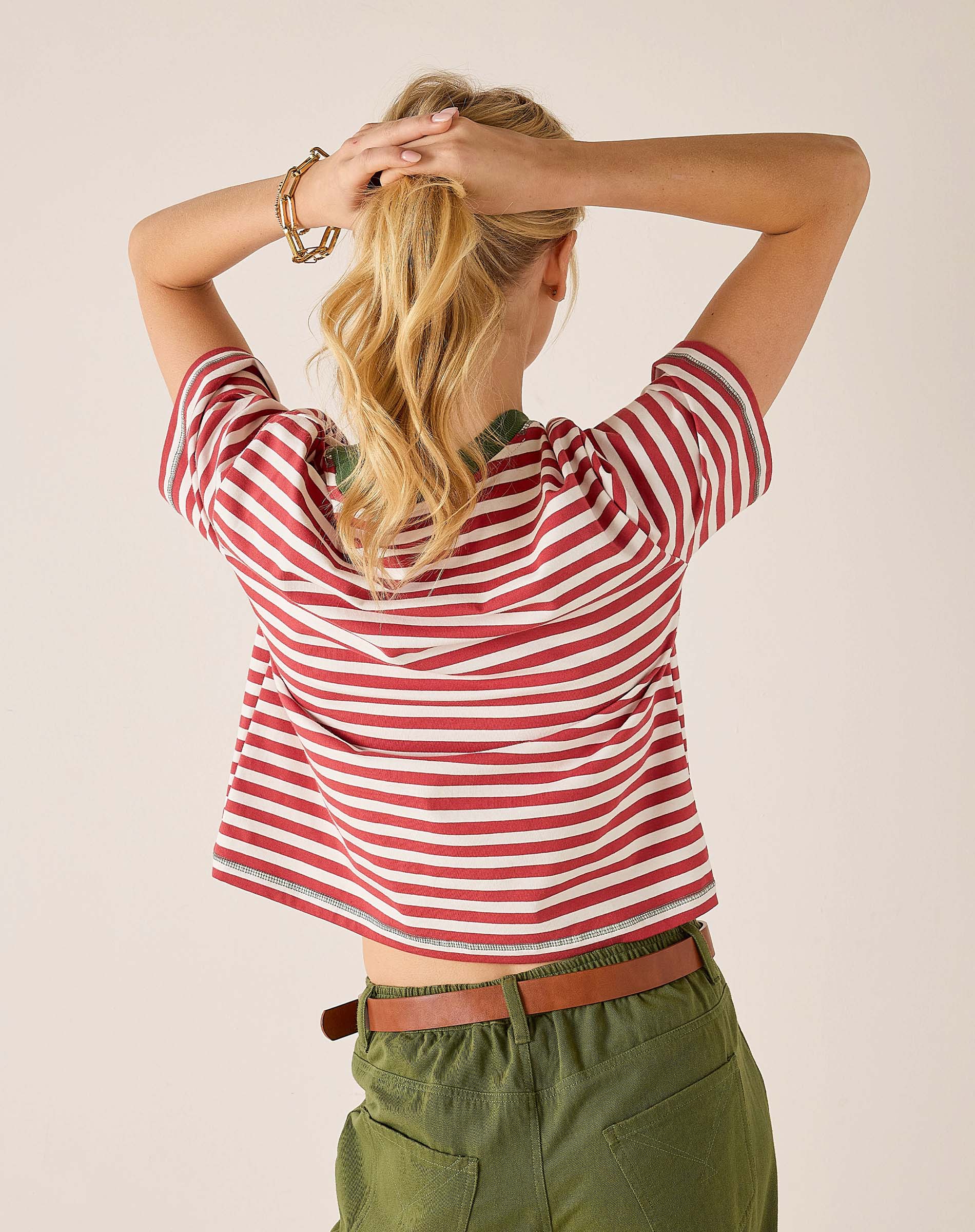 Back view of the currant-colored striped ringer tee with a boat neck and short sleeves.