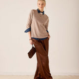 MERSEA women's travel-friendly fawn knit sweater over a blue shirt with wide-leg trousers.