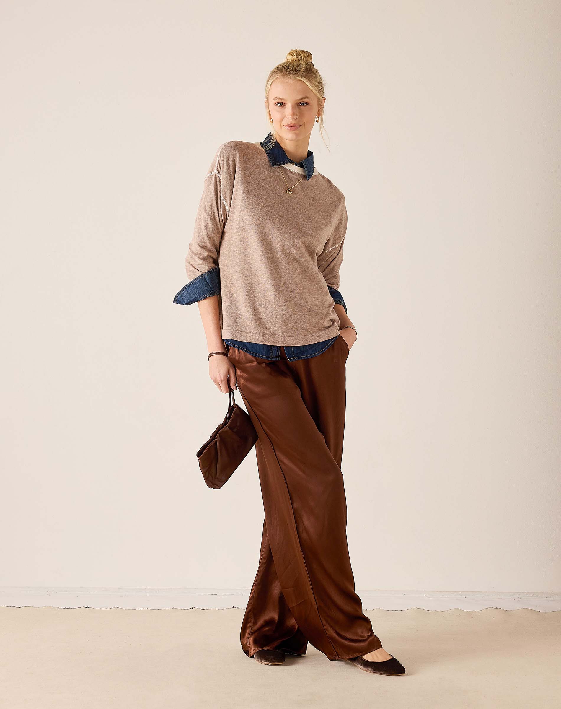 MERSEA women's travel-friendly fawn knit sweater over a blue shirt with wide-leg trousers.