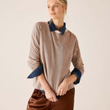 Fawn knit sweater with a button neckline and contrasting blue layered collar and cuffs.