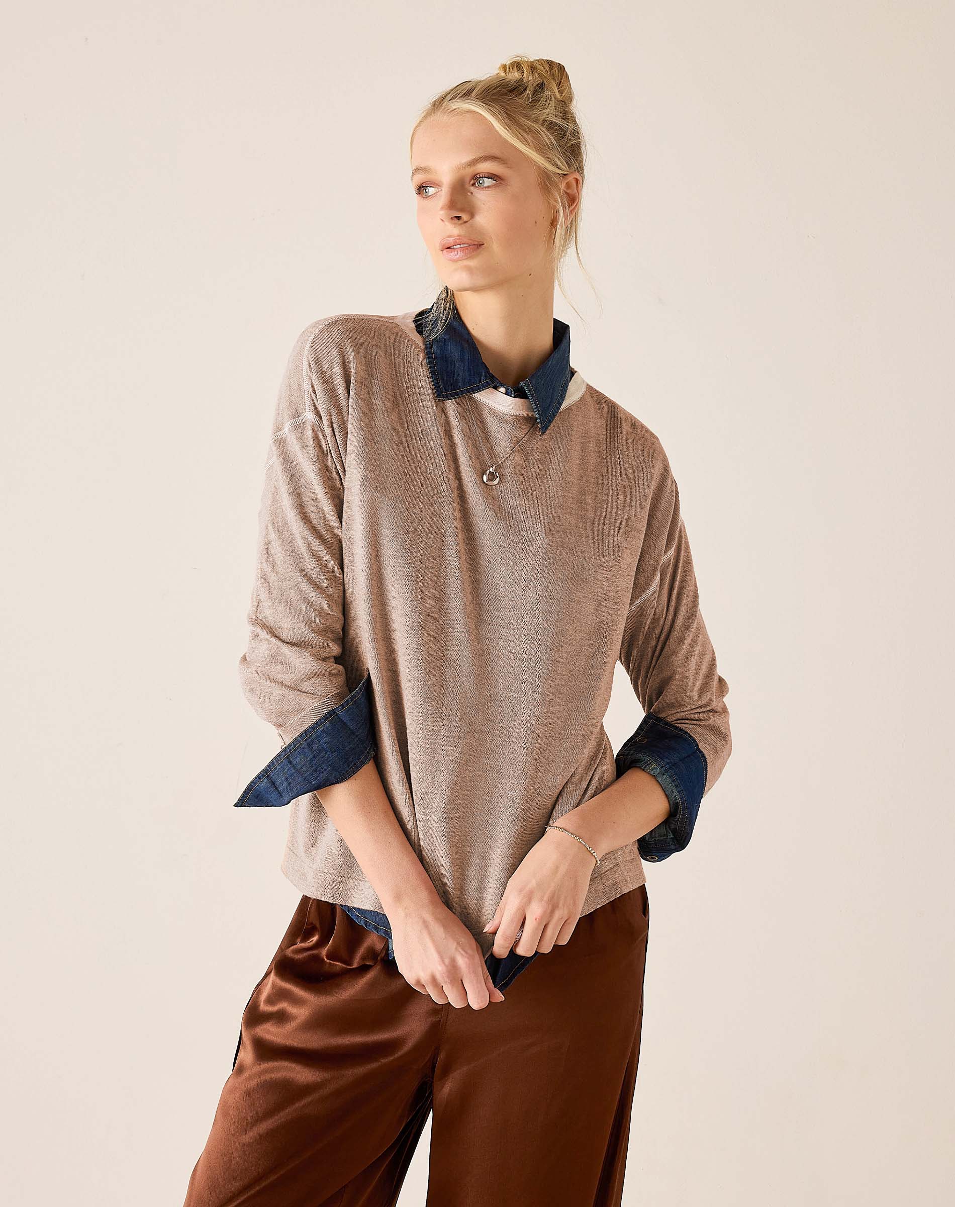 Fawn knit sweater with a button neckline and contrasting blue layered collar and cuffs.
