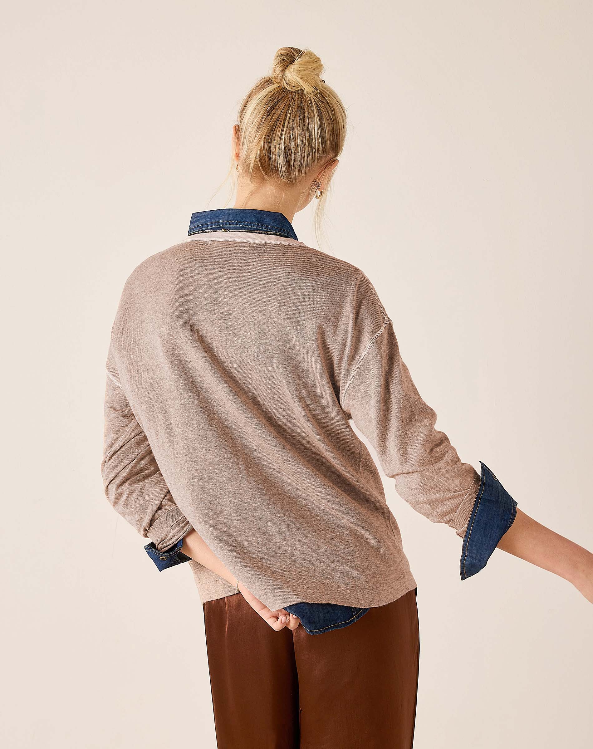 Back view of the fawn knit sweater with denim accents at the collar and cuffs.