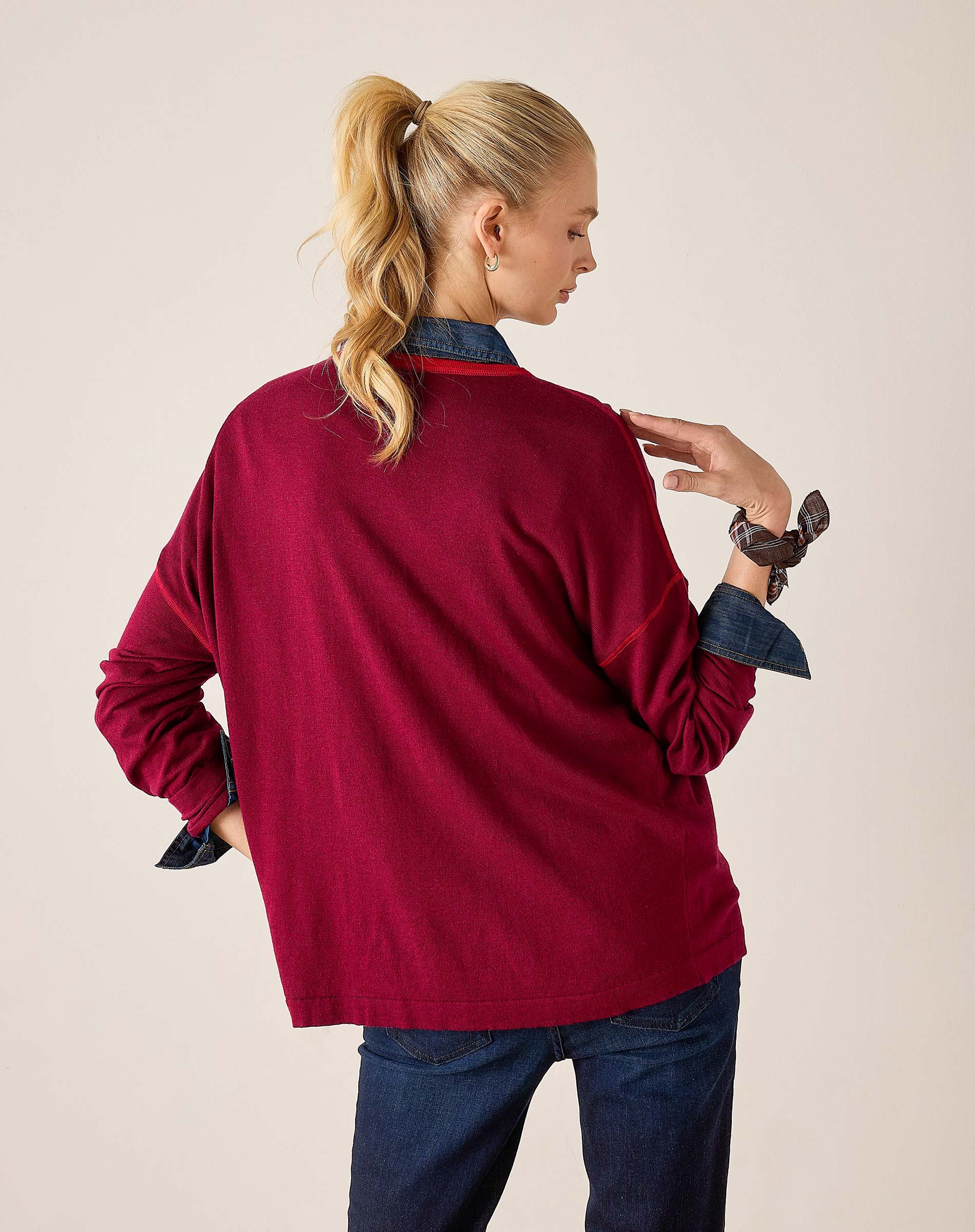 Back view of women's travel-friendly sangria knit sweater with contrasting dark trim and long sleeves.