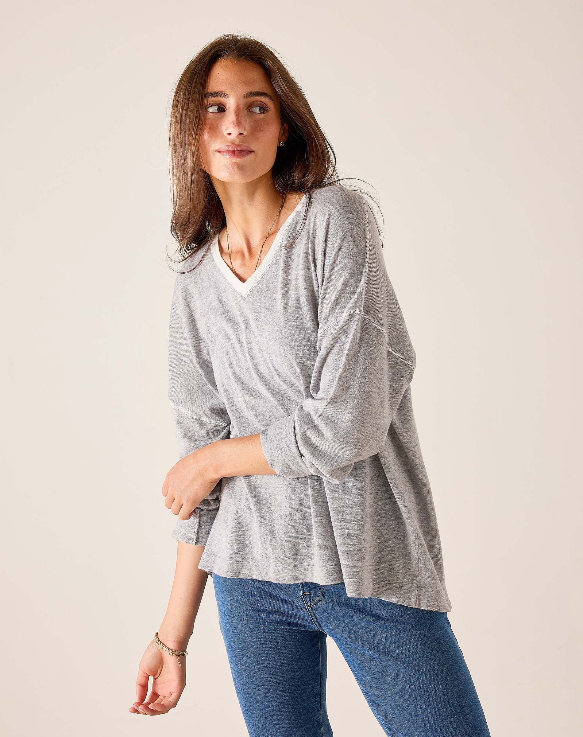 Silver cloud v-neck knit top with long sleeves and a relaxed fit.
