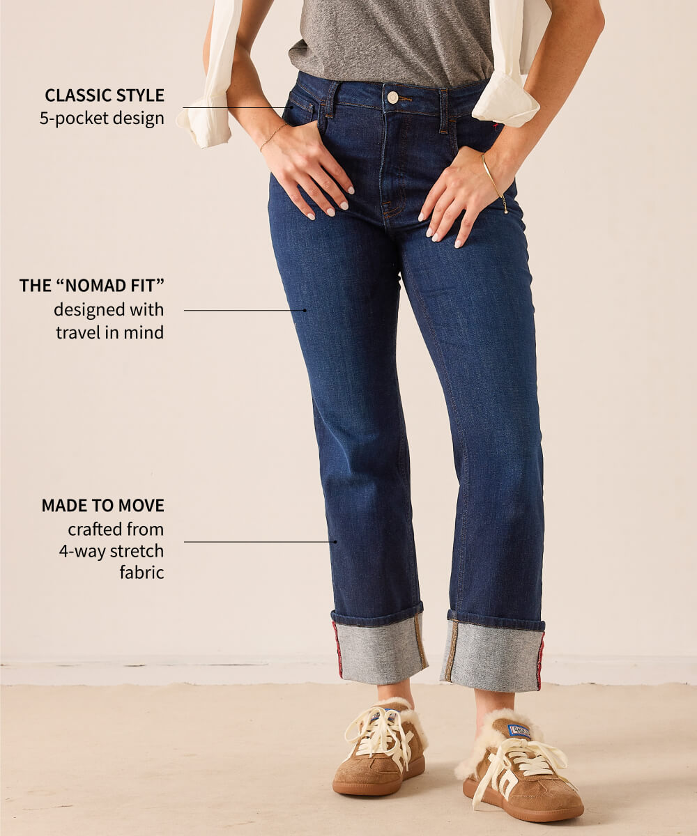 MERSEA ladies' travel-ready dark wash denim cropped trousers with a 4-way stretch fabric and rolled cuffs. Text on image: CLASSIC STYLE 5-pocket design; THE "NOMAD FIT" designed with travel in mind; MADE TO MOVE crafted from 4-way stretch fabric