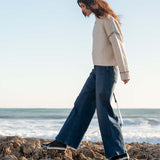 Cream whipstitch knit sweater featuring a side detail.
