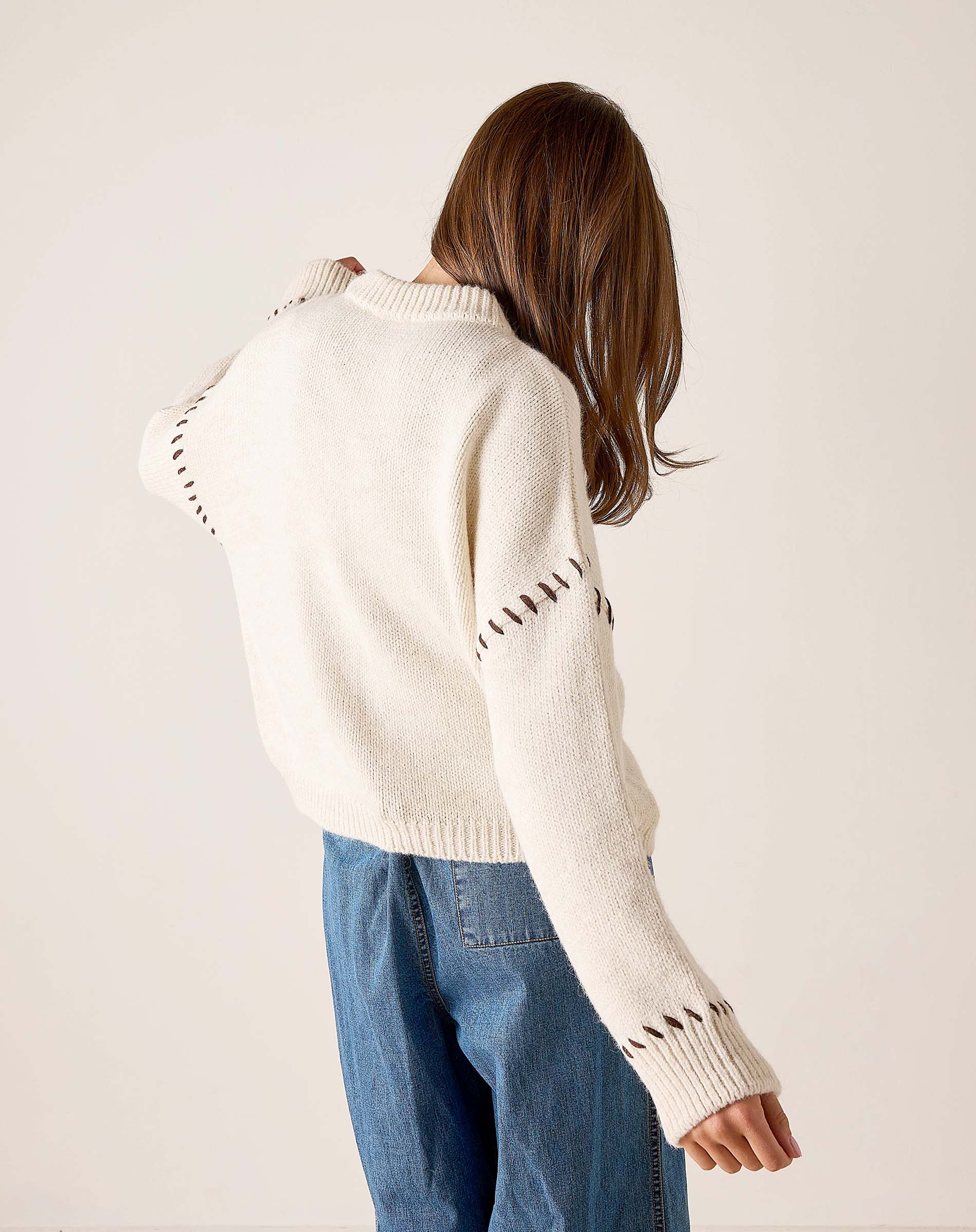 Cream whipstitch knit sweater with statement stitching detail