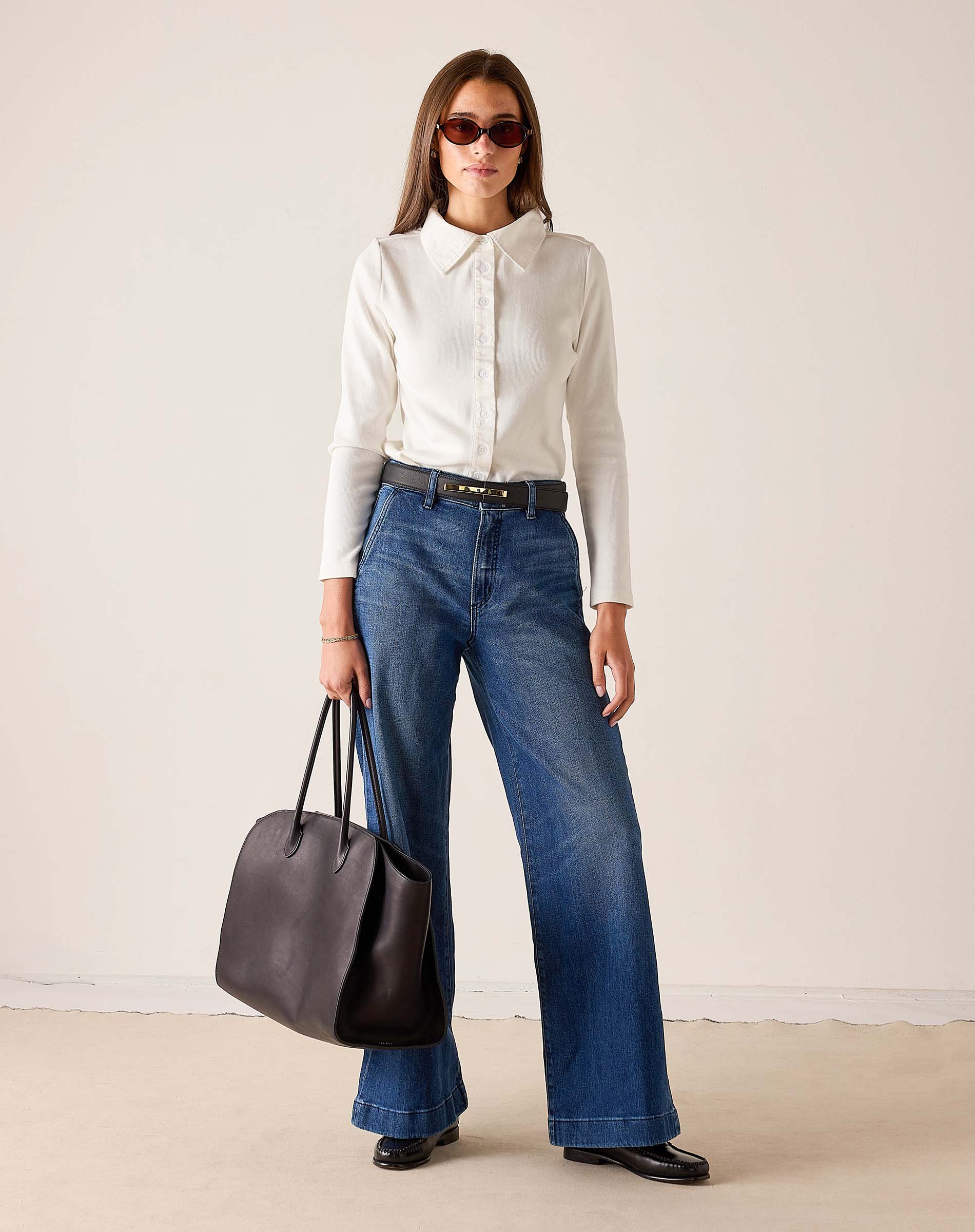 MERSEA women's travel-friendly ladies' travel-ready white ribbed oxford button-down shirt paired with high-waisted wide-leg denim jeans.