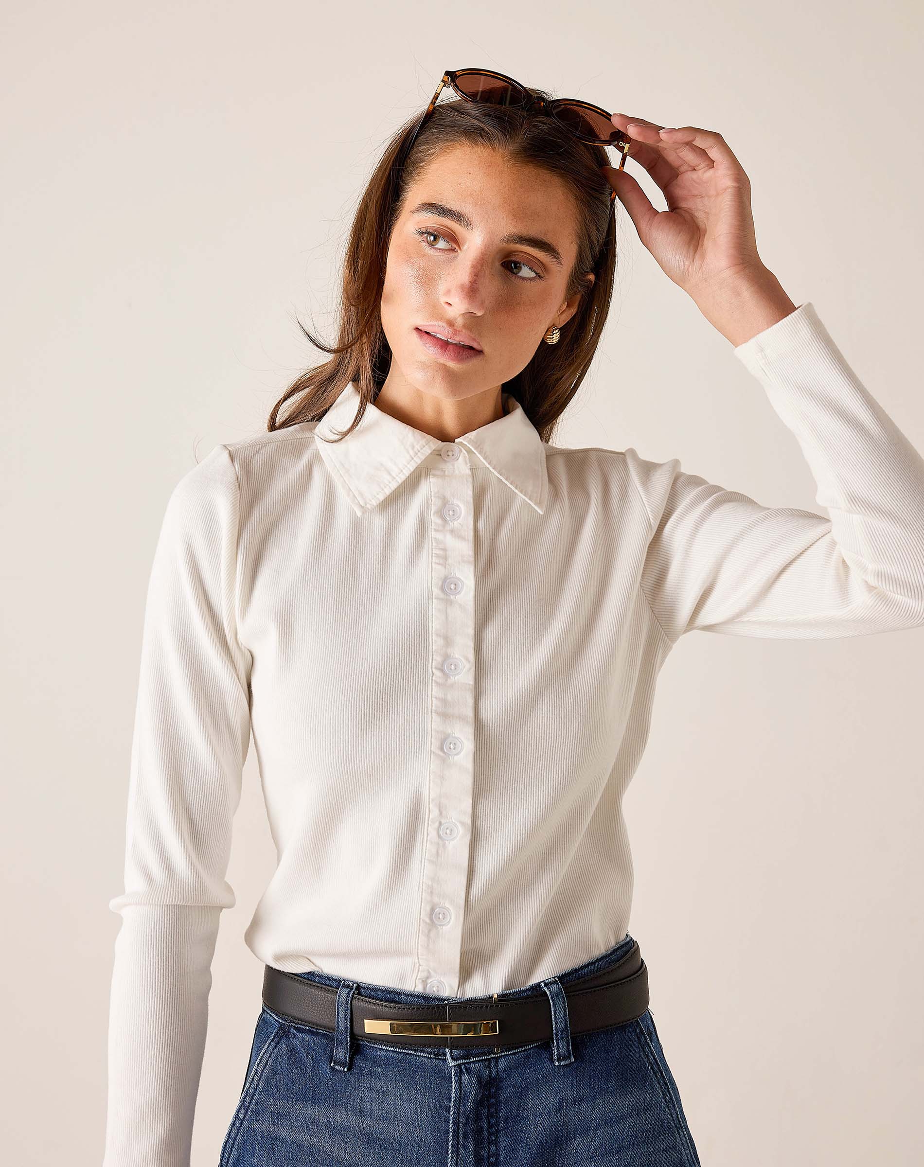 White ribbed oxford button-down shirt with a collar and long sleeves.