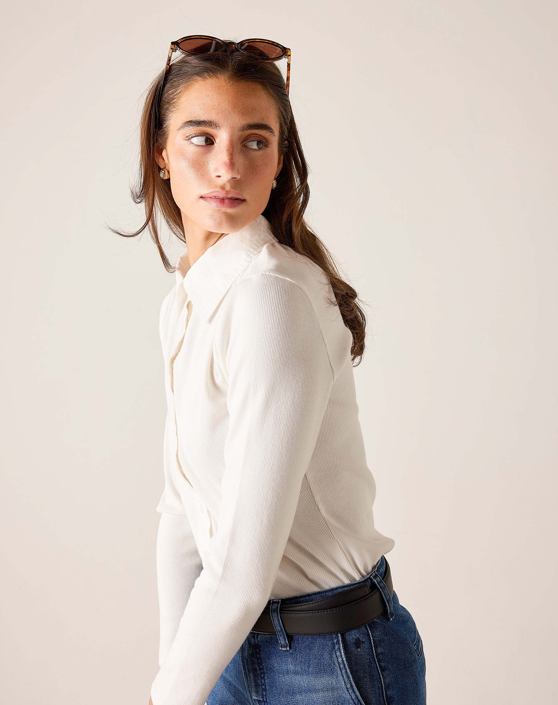 White ribbed Oxford button-down shirt with long sleeves and a collar.