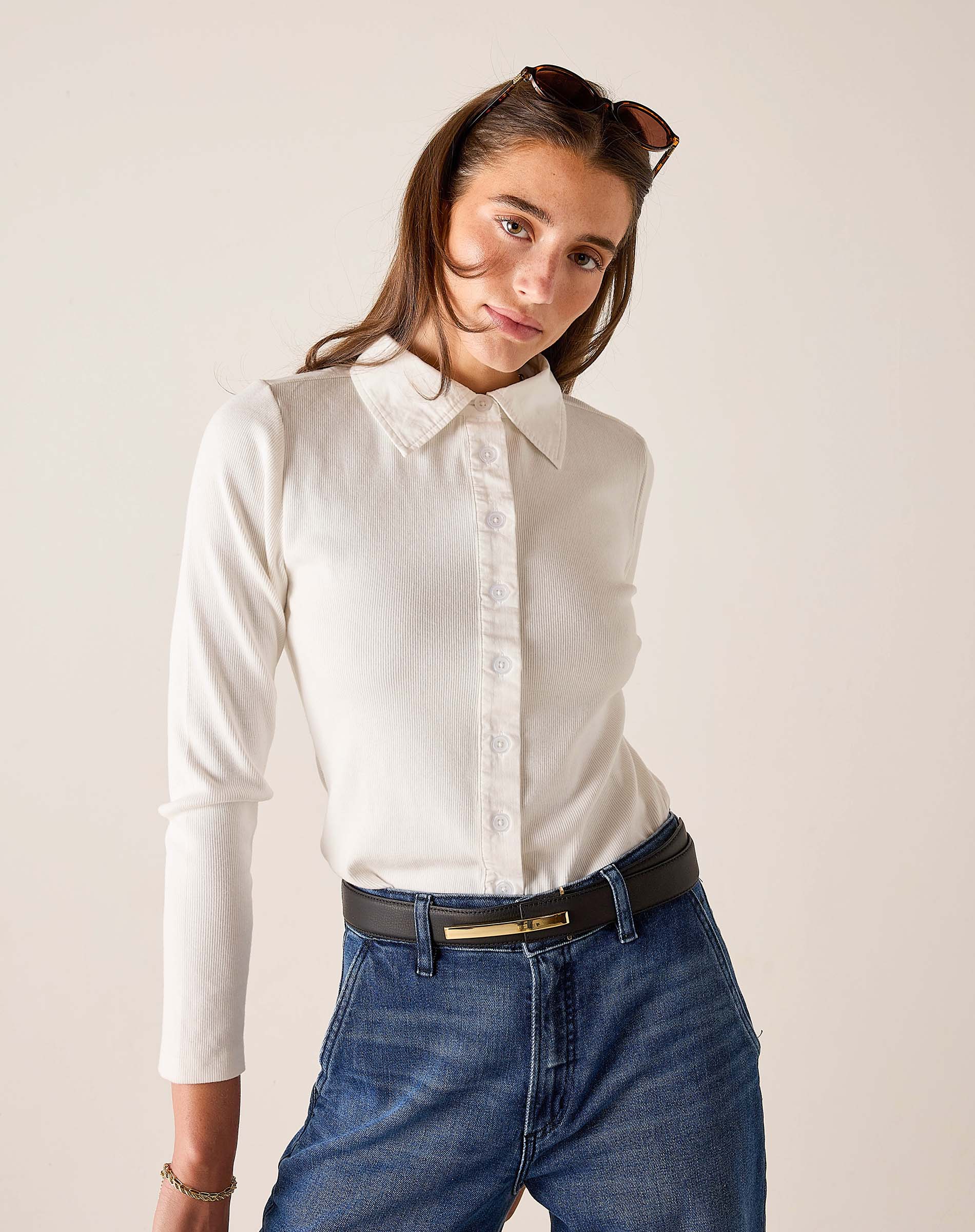White ribbed Oxford button-down shirt with a pointed collar and front buttons.
