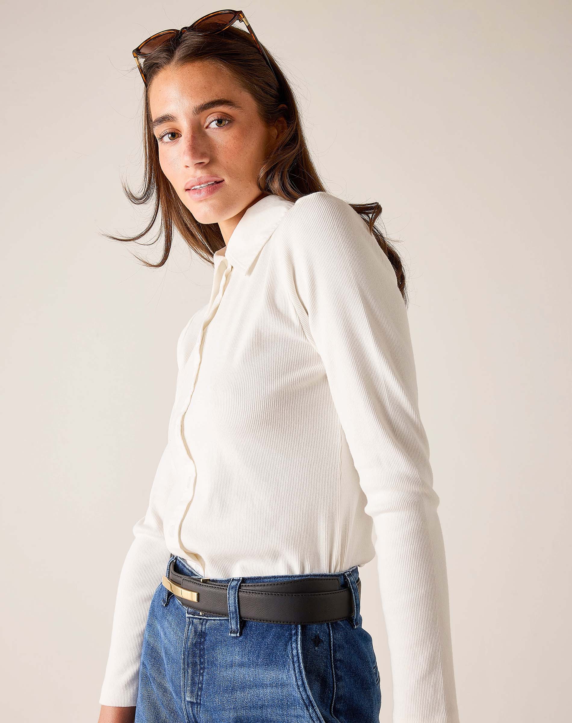 White button-down ribbed Oxford top with long sleeves and a collar.
