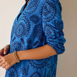 Blue patterned dress with a neutral background