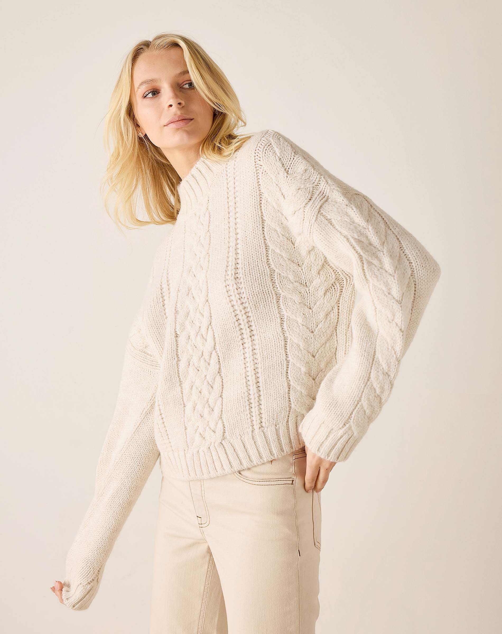 Cream cable knit sweater with ribbed details