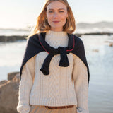 Cream cable knit sweater featuring a chunky ribbed texture and cozy oversized fit.