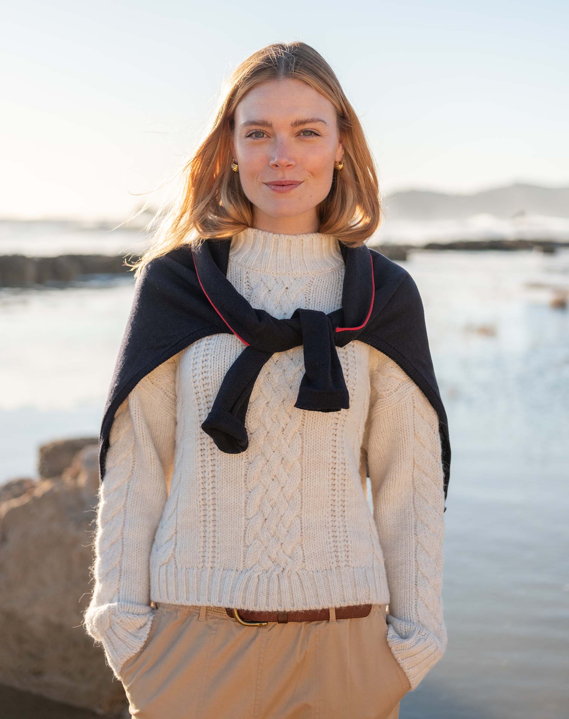 Cream cable knit sweater featuring a chunky ribbed texture and cozy oversized fit.