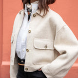 Dove white wool blend textured jacket featuring oversized pockets and button details.