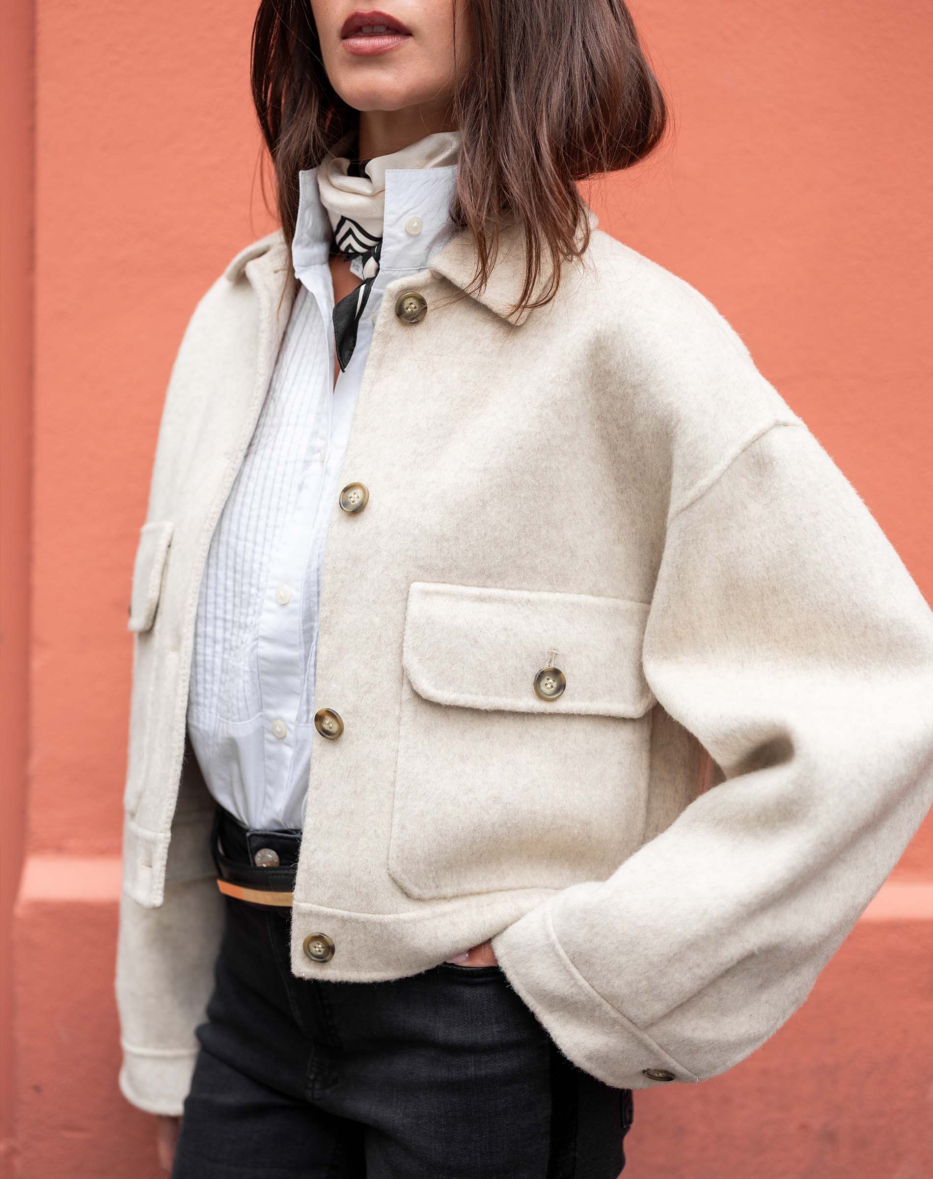 Dove white wool blend textured jacket featuring oversized pockets and button details.