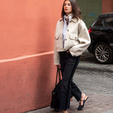 Dove beige wool-blend button-front jacket with oversized pockets and a high neck.