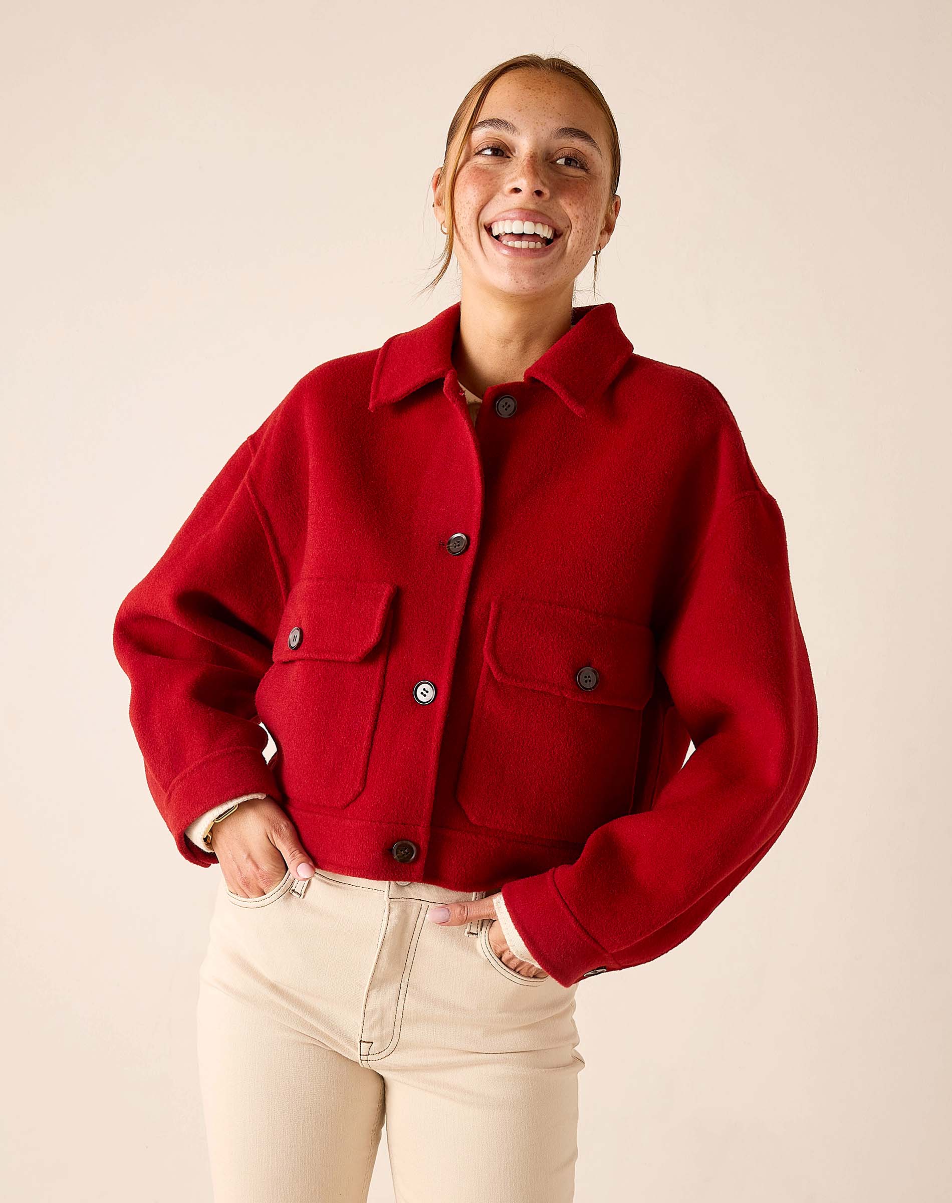 Garnet red wool-blend knit shirt jacket with a collar, front buttons, and large patch pockets.