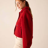 Garnet red wool-blend knit jacket with buttoned front and oversized pockets.