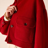 Garnet red knit wool jacket with large patch pockets and button details.