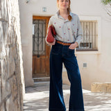 MERSEA ladies' travel-ready light grey shirt with cherry print, worn with high-waisted wide-leg jeans.