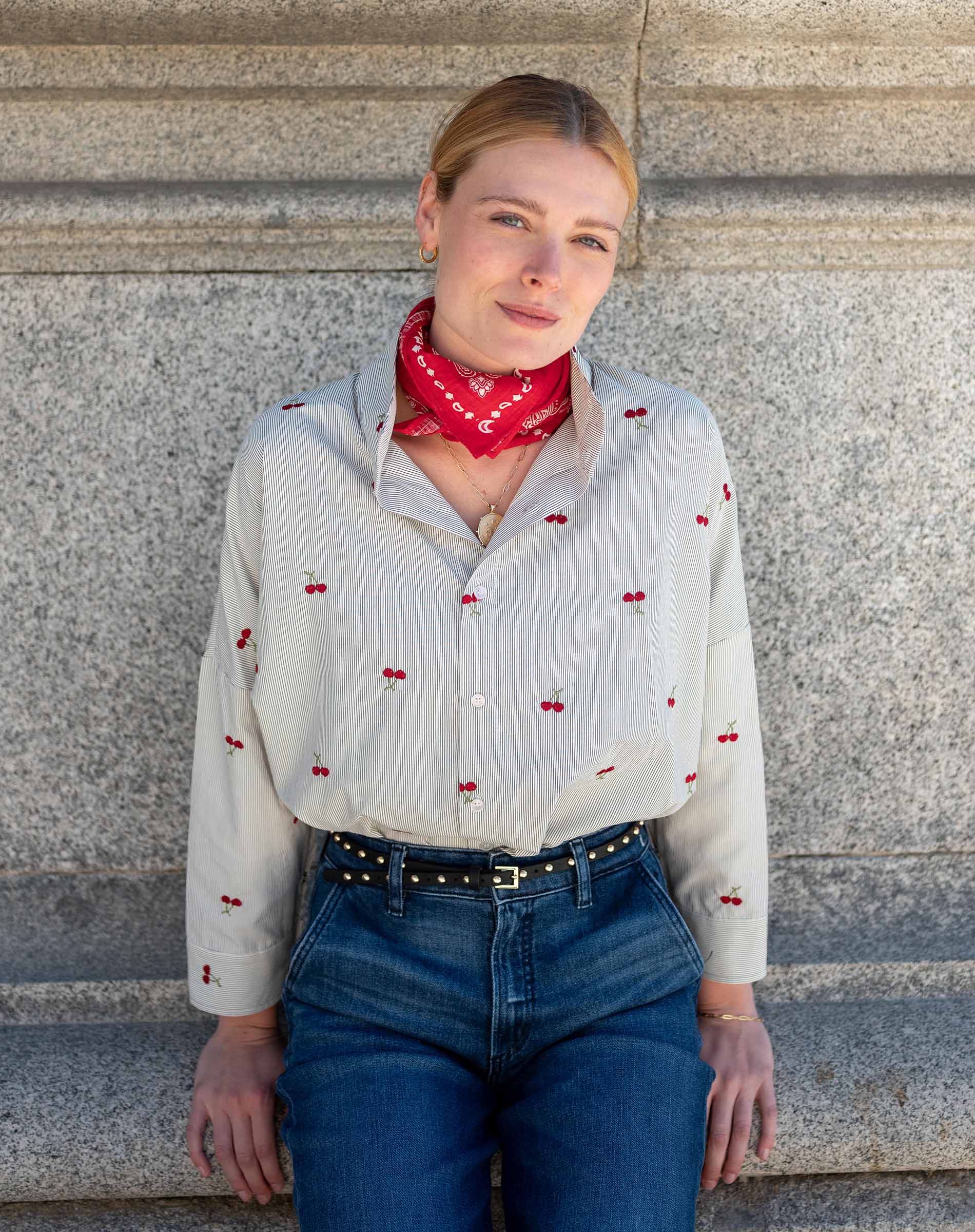 Off-white cherry print button-down shirt with long sleeves and a red patterned bandana.