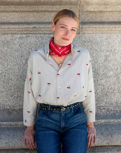 Off-white cherry print button-down shirt with long sleeves and a red patterned bandana.