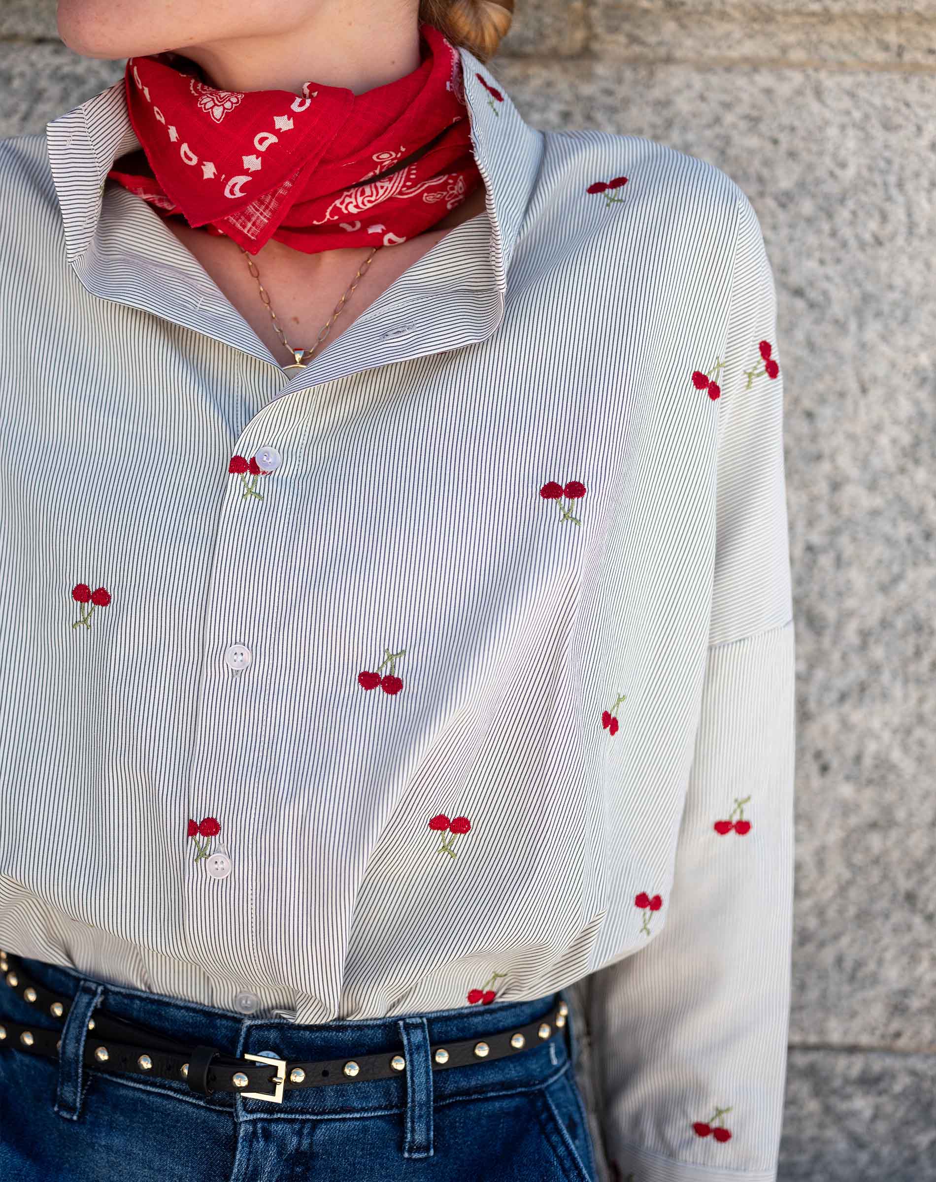 White pinstripe button-down shirt with a cherry print and long sleeves.