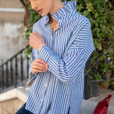 Blue double stripe button-up top with an Elizabethan collar and long sleeves.