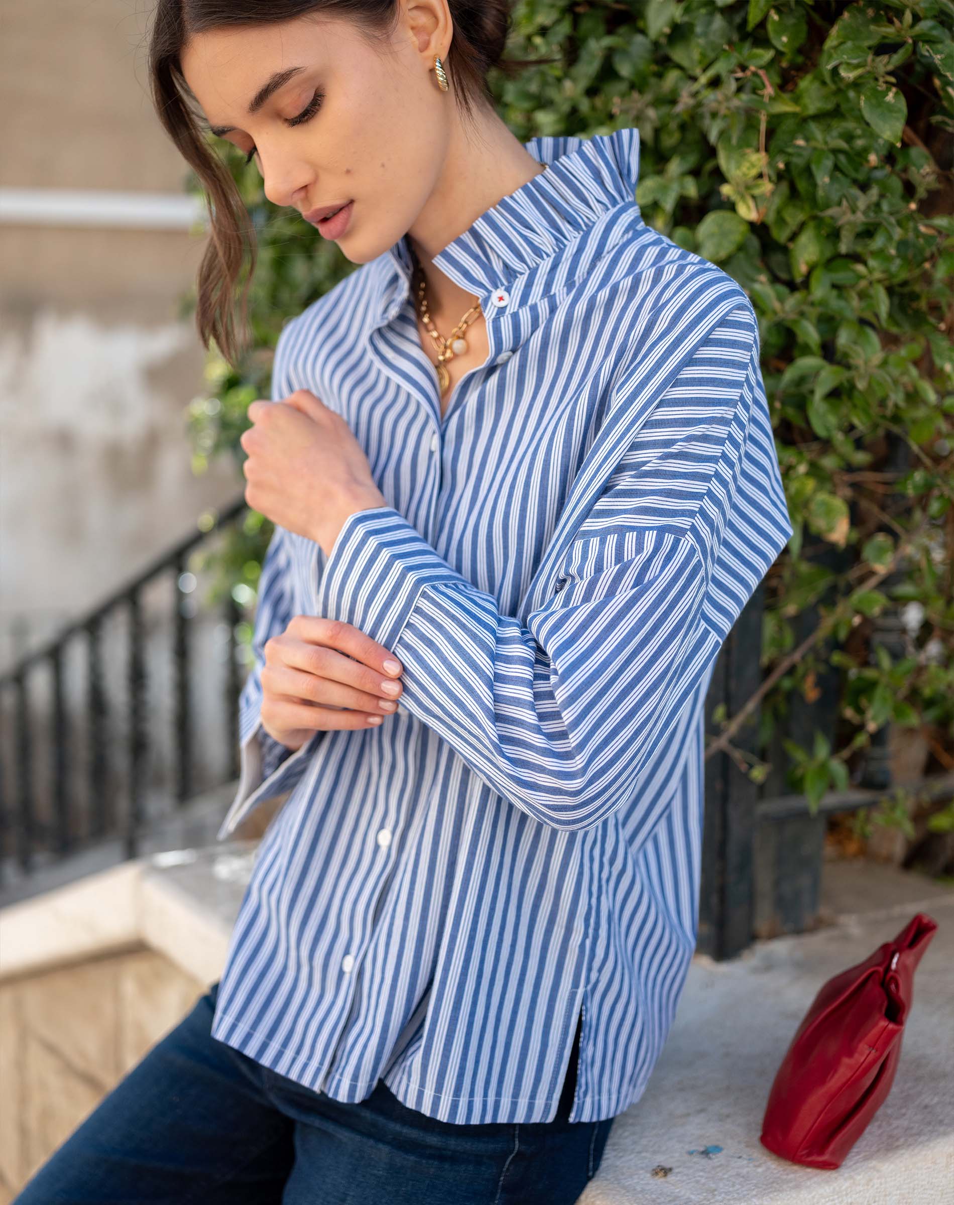 Blue double stripe button-up top with an Elizabethan collar and long sleeves.