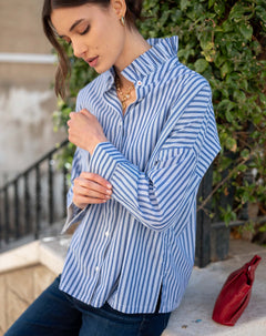 Blue double stripe button-up top with an Elizabethan collar and long sleeves.