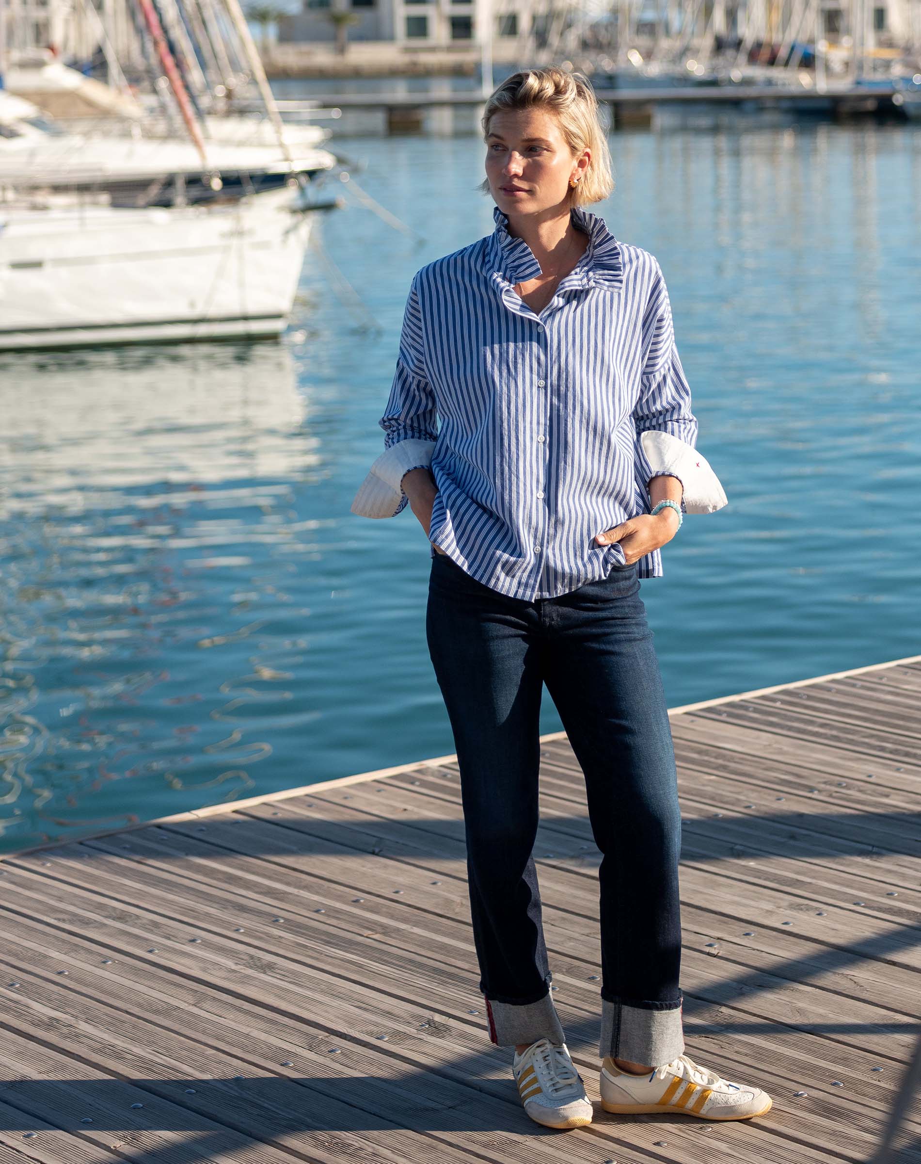 Blue and white double-striped Elizabethan collar top with buttoned cuffs and rolled sleeves.