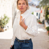 MERSEA ladies' travel-ready white Elizabethan collar top with ruffled detail and long sleeves.