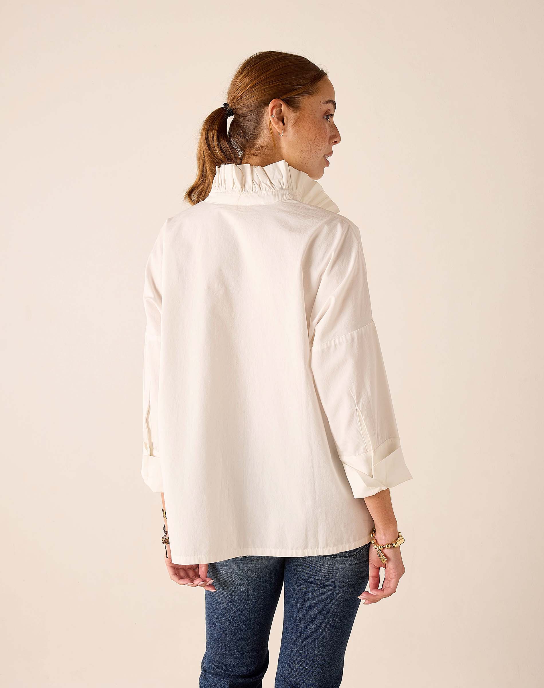 Back view of the white Elizabethan collar top.