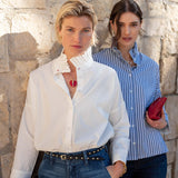 White Elizabethan collar top with ruffled neck detail and long sleeves.