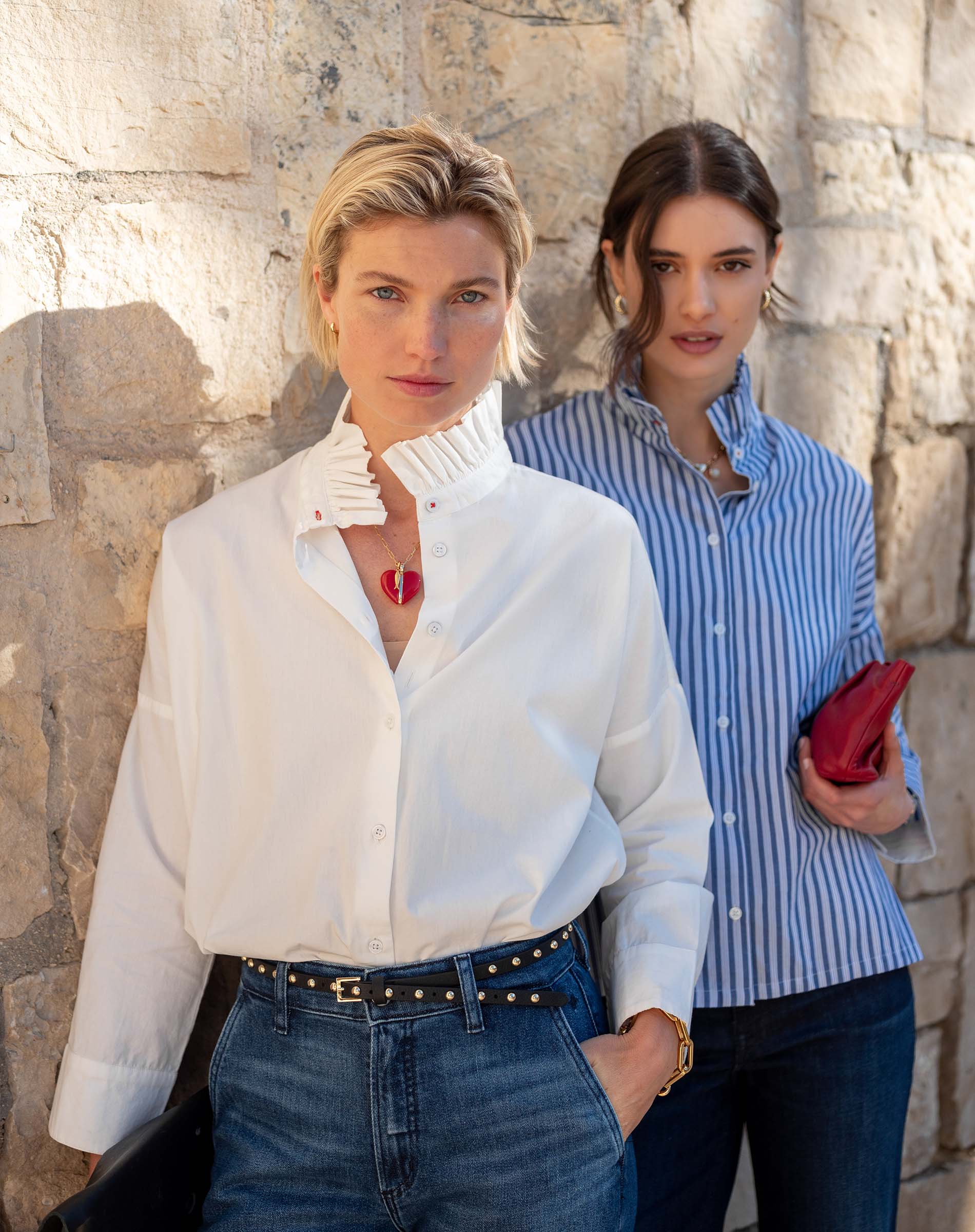 White Elizabethan collar top with ruffled neck detail and long sleeves.